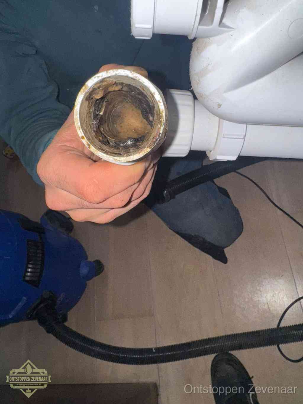 Een losgekoppeld afvoerbuisstuk dat van binnen volledig is dichtgeslibd, het gevolg van een verstopping te lang laten zitten in Zevenaar